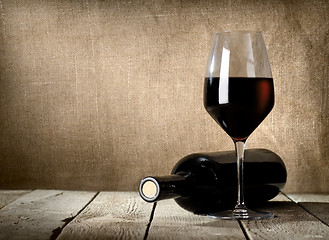 Image showing Black bottle and red wine