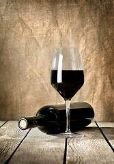 Image showing Black bottle of wine and wneglass