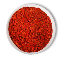 Image showing Ground paprika in plate isolated