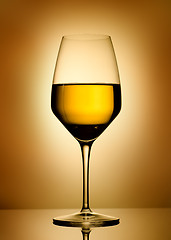 Image showing Wine glass  over gold background