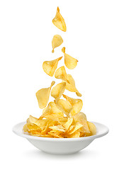 Image showing Potato chips falling in the plate