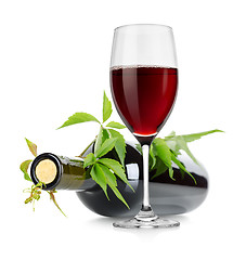 Image showing Wineglass and wine bottle with vine