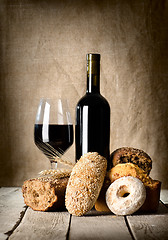 Image showing Wine and assortment of bread