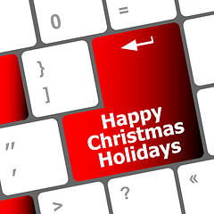 Image showing happy christmas holidays button on computer keyboard key