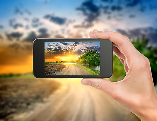 Image showing Phone and evening landscape