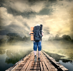 Image showing Tourist on the wooden bridge