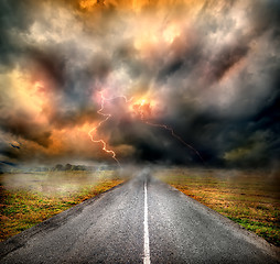 Image showing Storm clouds and lightning over highway