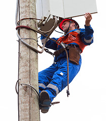 Image showing Electrician opened the control panel on the pole reclosers