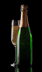Image showing Glass and bottle of champagne