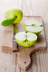 Image showing fresh green sliced apples and knife 