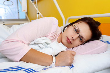 Image showing sad middle-aged woman lying in hospital