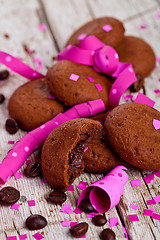 Image showing fresh chocolate cookies, coffee beans, pink ribbons and confetti