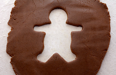 Image showing Cutout shape of a gingerbread man in cookie dough