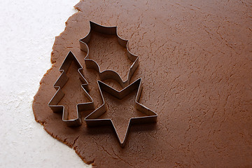 Image showing Cutting out Christmas shapes from gingerbread dough