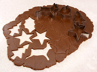 Image showing Gingerbread dough cutout shapes and biscuit cutters