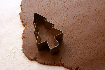 Image showing Cutting out a Christmas tree from gingerbread