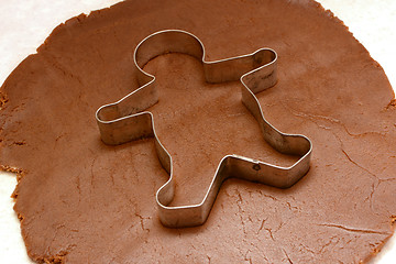 Image showing Gingerbread man cutter on cookie dough