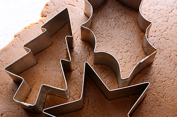 Image showing Festive cookie cutters on gingerbread dough