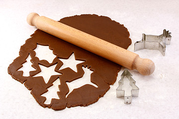 Image showing Rolling pin and festive cookie cutters with gingerbread dough