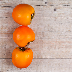 Image showing three fresh persimmons 