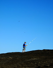 Image showing Fishing on top of the rock, near the sea