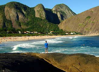 Image showing Fishing on top of the rock at the beach