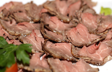 Image showing Tapping on a platter of meat