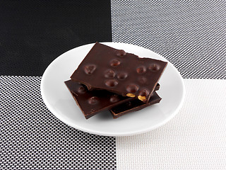 Image showing Cracked chocolate parts in white plate