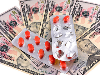 Image showing medical pills on dollars bank note as symbol for high costs