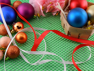 Image showing beautiful flowers, gifts and Christmas balls on green background