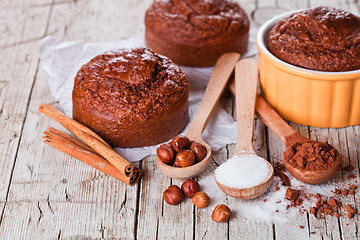 Image showing fresh baked browny cakes, sugar, hazelnuts and cocoa powder 