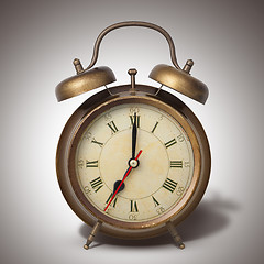 Image showing Brown old style alarm clock with shadow
