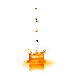 Image showing drop falling into orange water with splash isolated on white