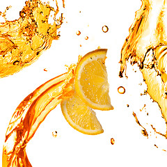 Image showing orange slices and splashes of juice isolated on white