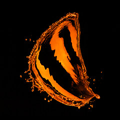 Image showing orange water splash isolated on black