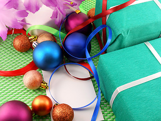 Image showing A gift box with a white ribbon and new year balls