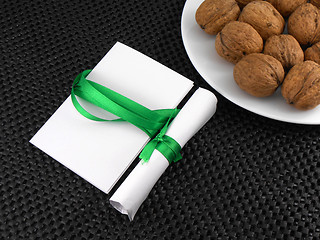 Image showing Walnuts on a white plate with invitation card