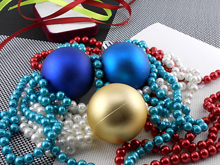 Image showing christmas ball and pearls on a plate, new year holiday card