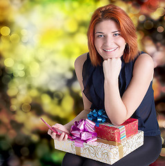 Image showing Emotional smiling woman with boxes gifts