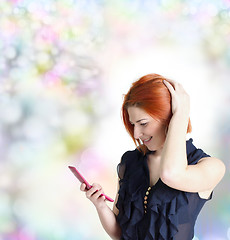 Image showing Joyful Emotional happy woman with red hair and a telephone