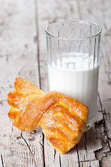 Image showing glass of milk and fresh baked bun 