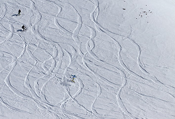 Image showing Snowboarders and skiers downhill on off piste slope.