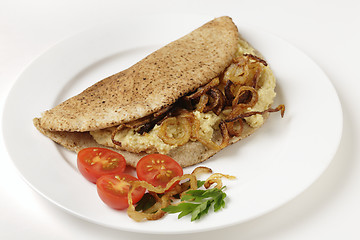 Image showing Pitta bread with hommos and onions