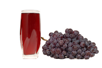 Image showing A glass of grape juice with a cluster of grapes