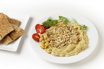 Image showing Lebanese hummus and pine nuts