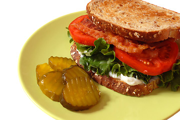 Image showing Closeup of a bacon, lettuce and tomato sandwich with pickles