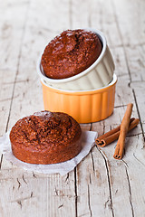 Image showing fresh baked browny cakes and cinnamon sticks