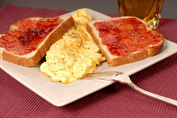 Image showing Omelette with toast, strawberry jam and apple juice