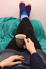 Image showing Woman dressed warmly, relaxing with a hot drink