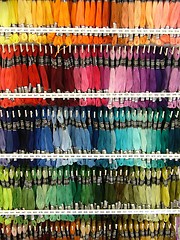 Image showing bundles of threads hanging in the shop - rainbow colors :)